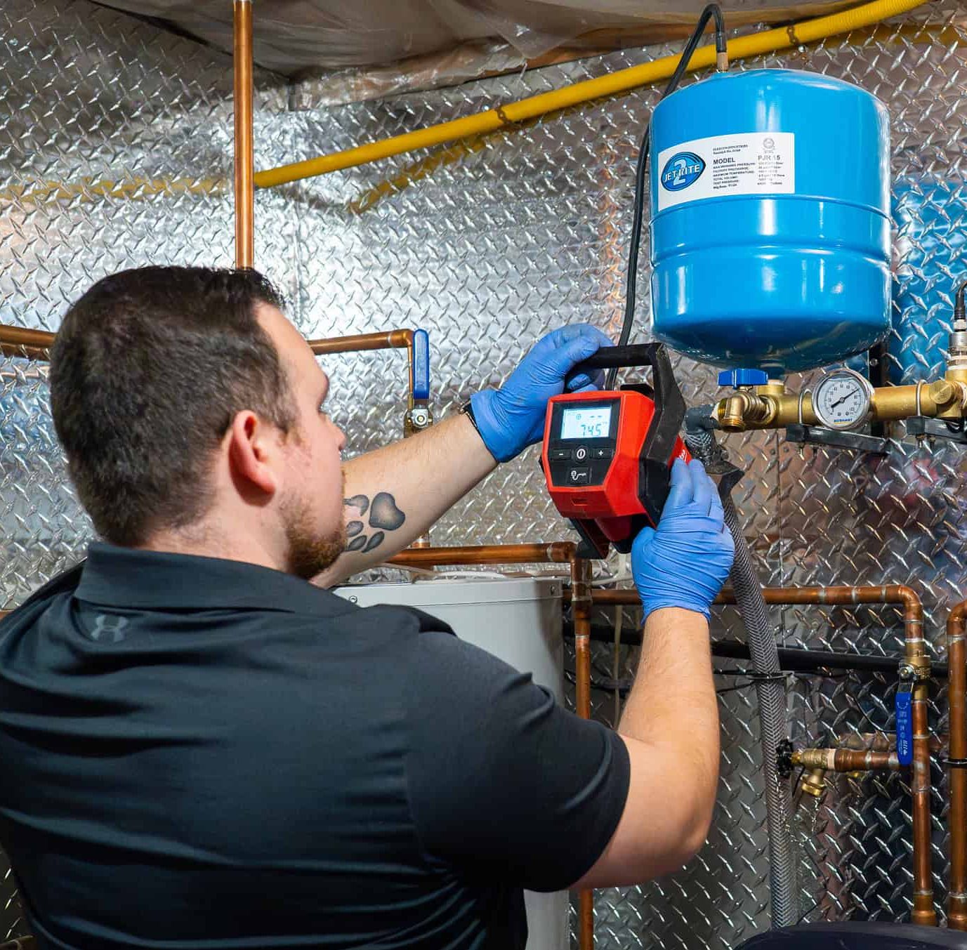 Nelson Water technician servicing a well pressure tank system in Ottawa